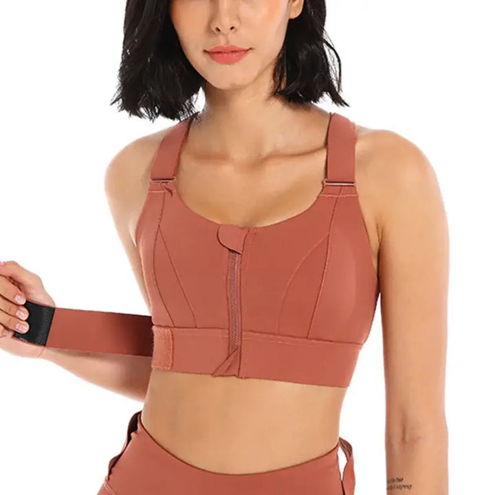 Front Zipper High Impact Sports Bra for Plus Size Women, featuring adjustable straps and secure fit in rust color.