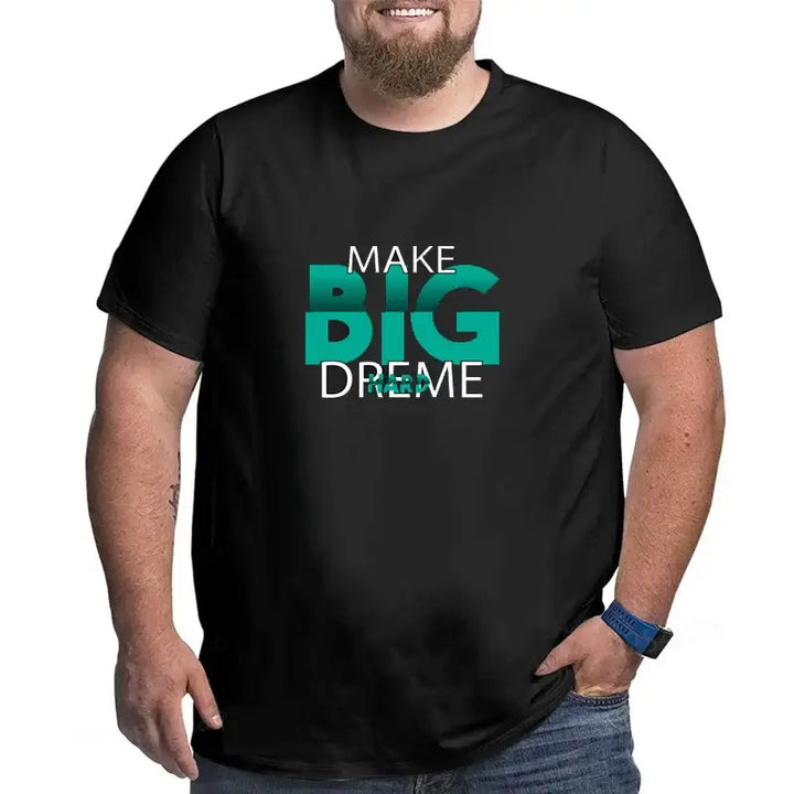 Plus size man wearing an oversized black cotton T-shirt with "MAKE BIG DREAMS" graphic print, perfect for stylish summer comfort.