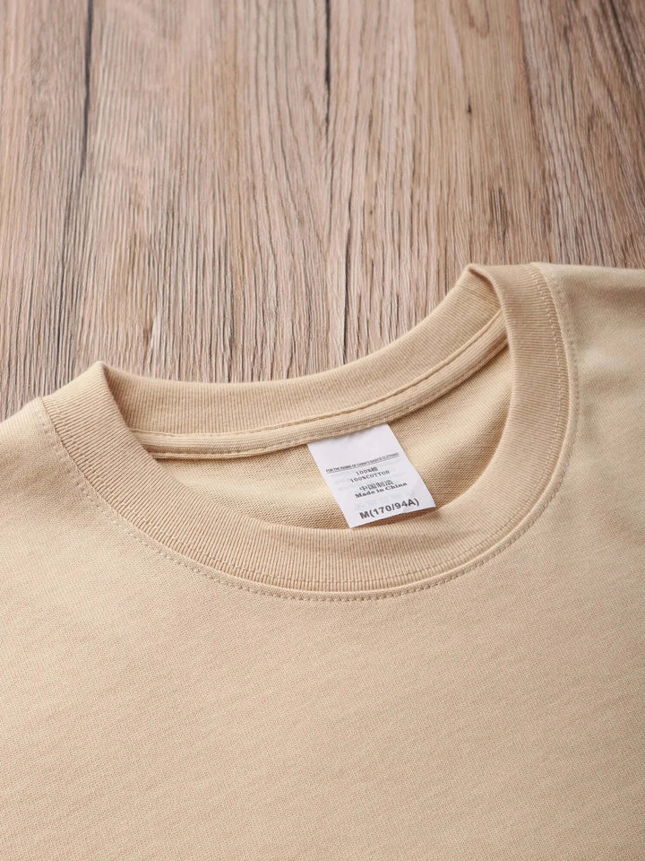 Oversized unisex cotton t-shirt with classic collar on wooden surface