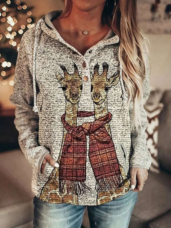 Woman wearing a cozy vintage graphic hoodie with giraffe print and a plaid scarf design, perfect for autumn style.