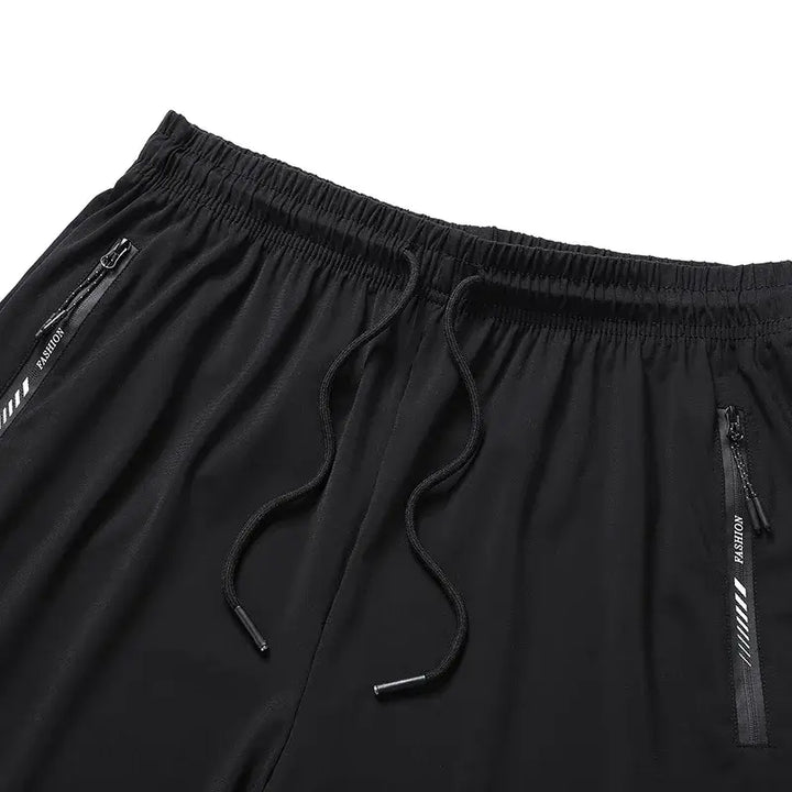 Black men's plus size short sweatpants with drawstring, featuring zippered pockets for summer comfort and style.