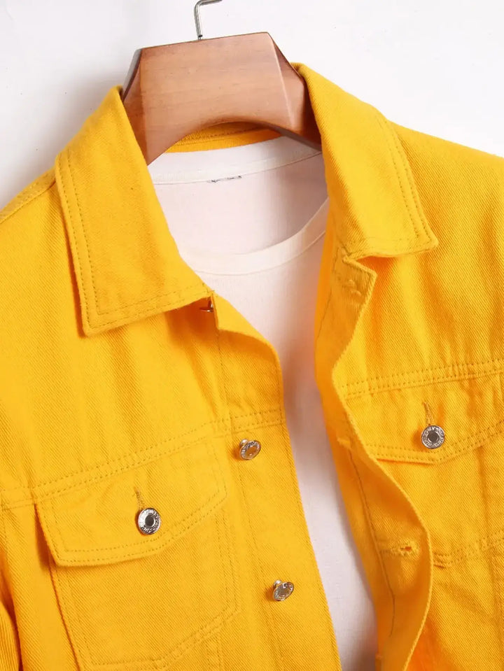 Bright yellow denim jacket on hanger with white shirt underneath