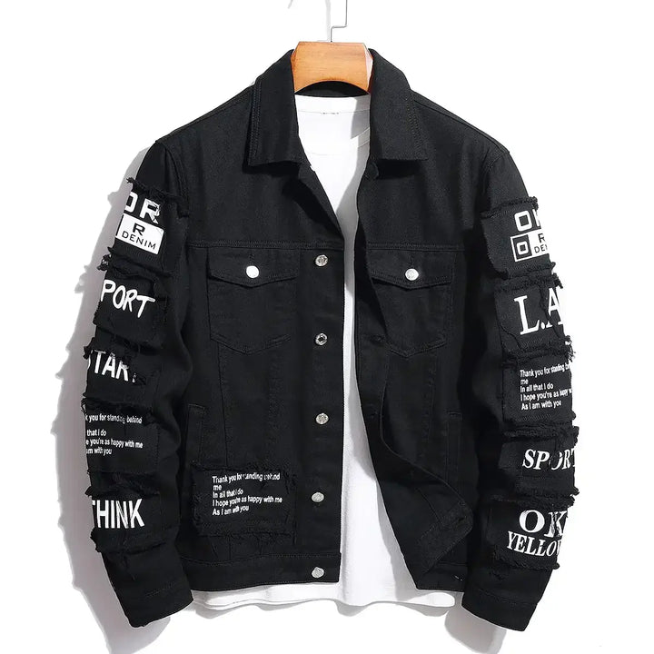 Men's black denim jacket with text patches, featuring vintage streetwear style and modern comfort.