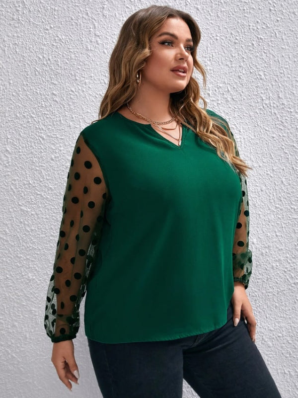 Plus size woman wearing a green formal mesh long sleeve top with polka dot design, ideal for stylish formal events.